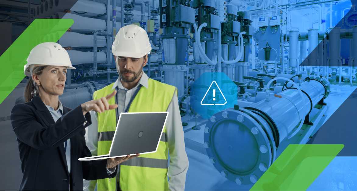 Two managers in hard hats on a laptop